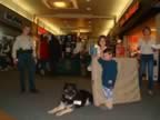 Officer Lang, Amigo, and winners of the grand door prize Denise Guizio and family. (42kb)